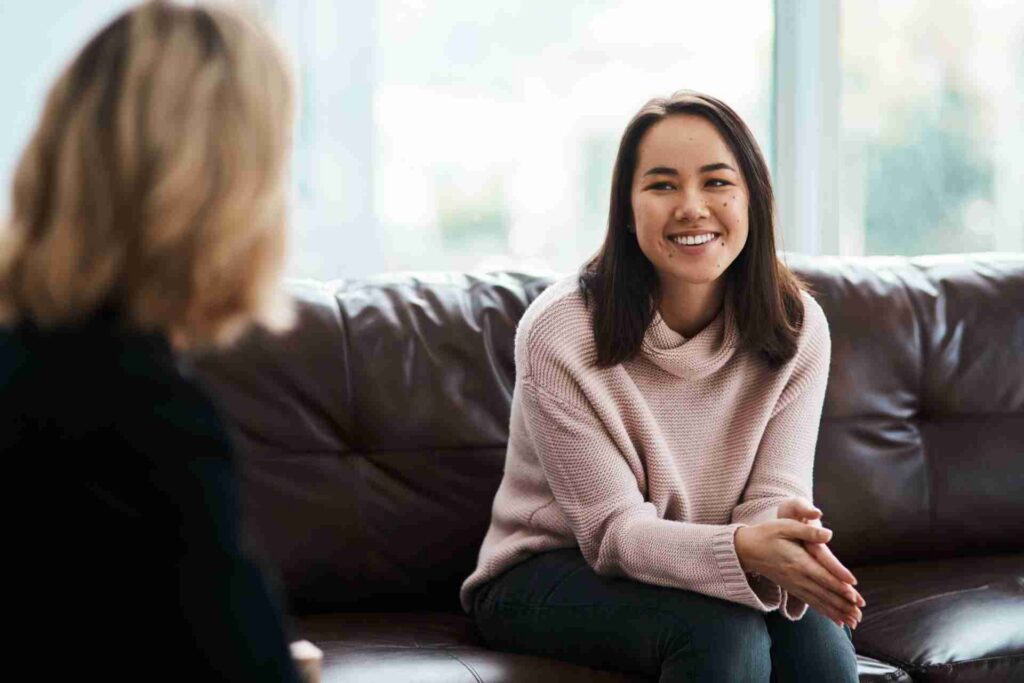 Person smiling during a mental health therapy session in PHP or IOP program