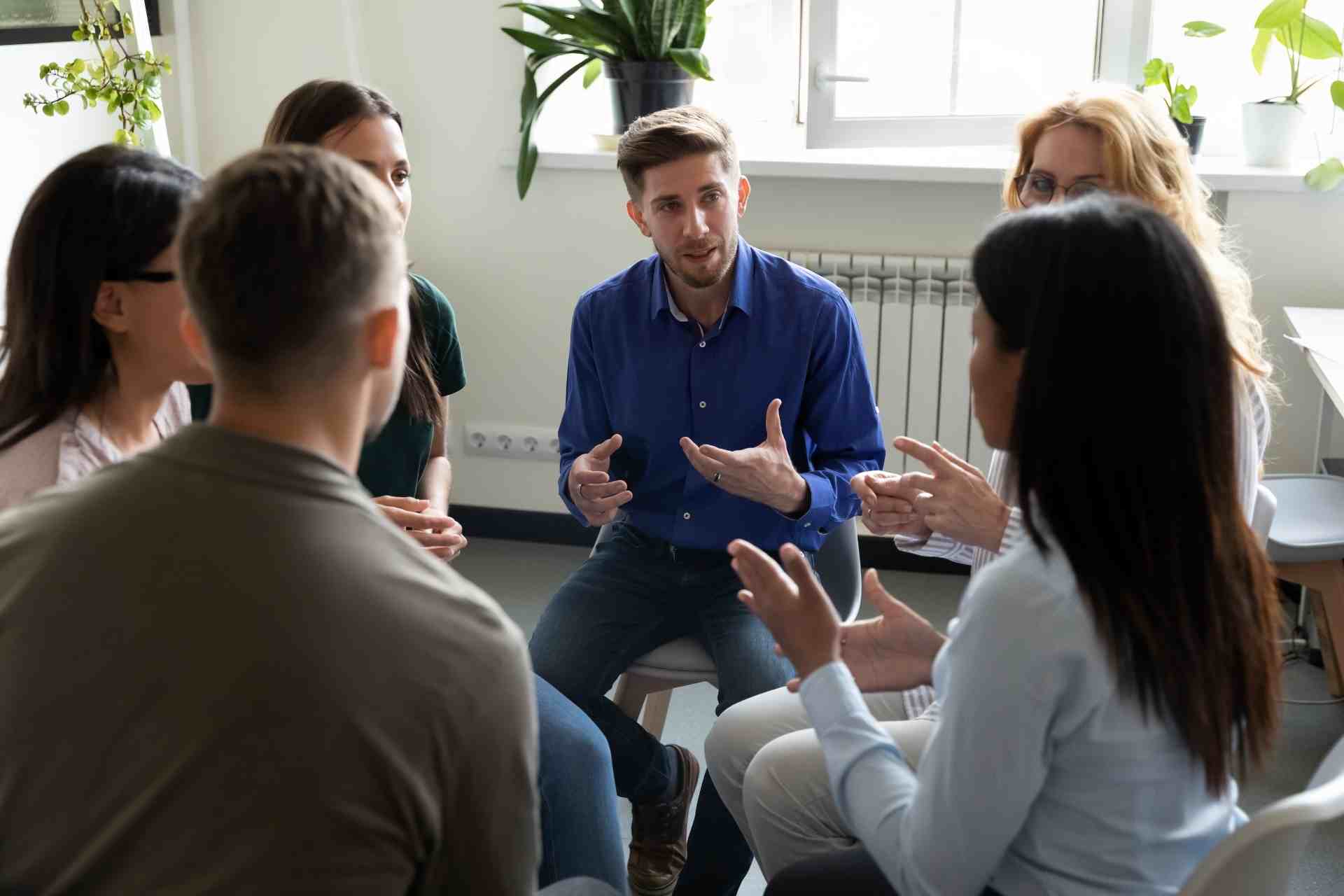 Therapist leading group therapy session in PHP or IOP mental health program