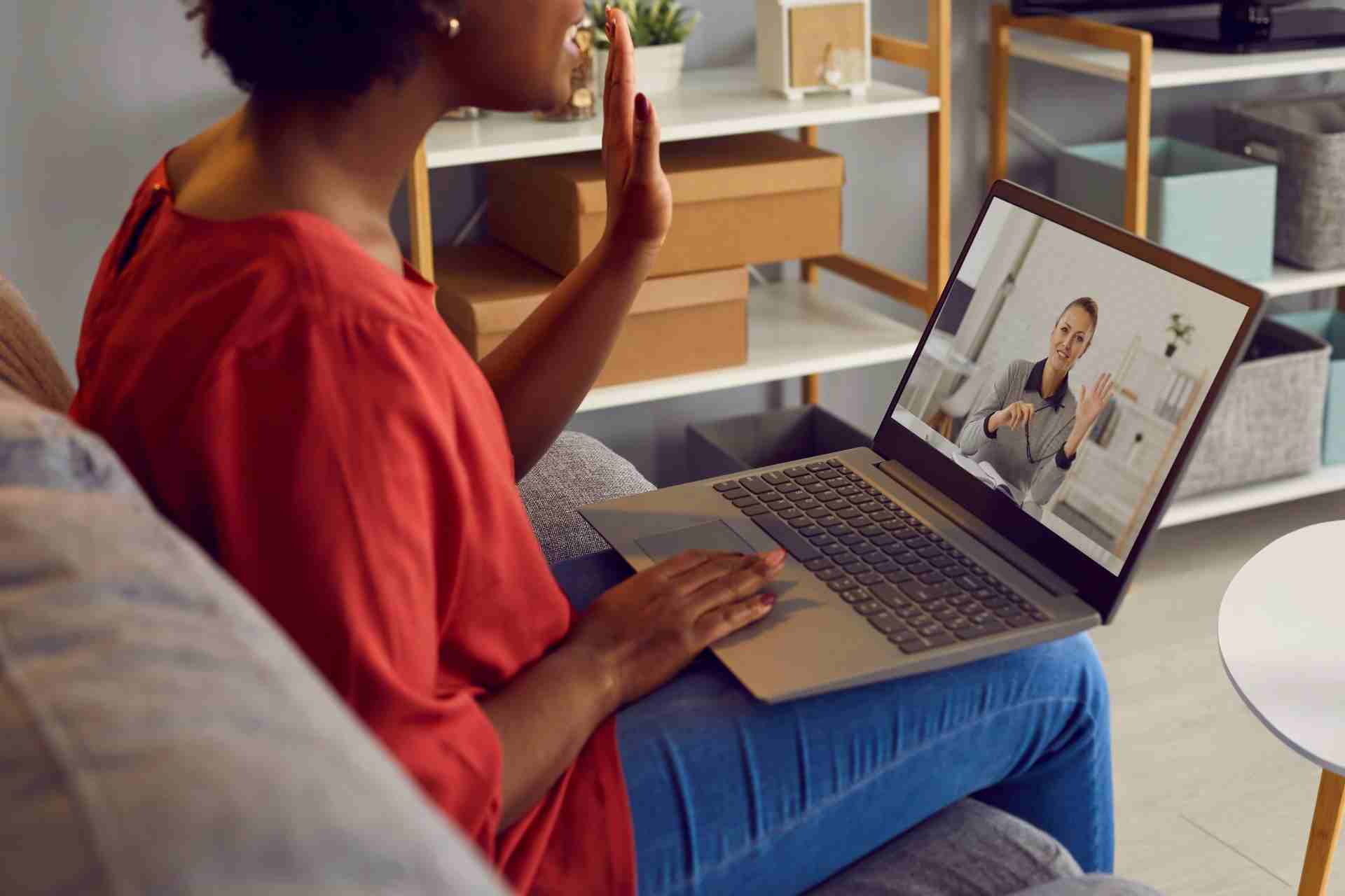 Client attending a virtual intensive outpatient program therapy session from home using a laptop.