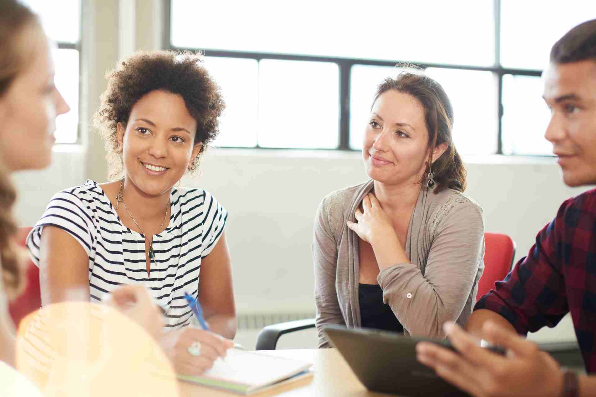 Adults participating in a structured mental health group therapy discussion during PHP or IOP treatment